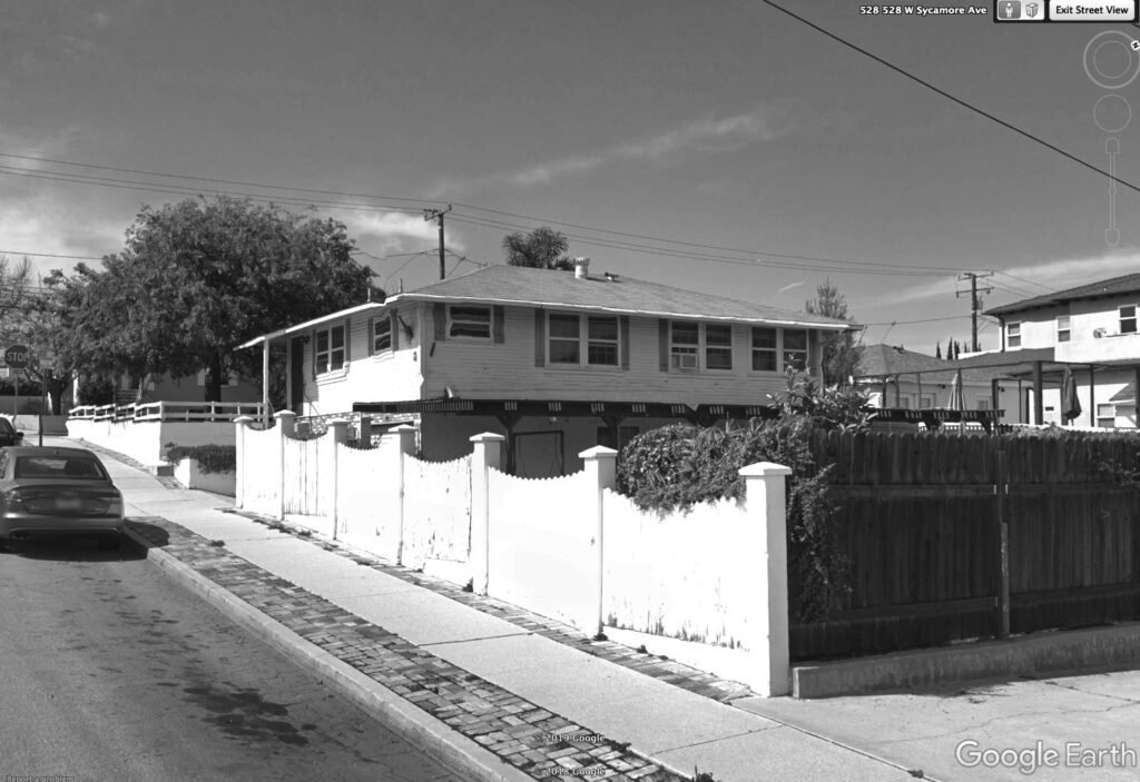 Before renovation back side of the house with a visible second story and visible slant.